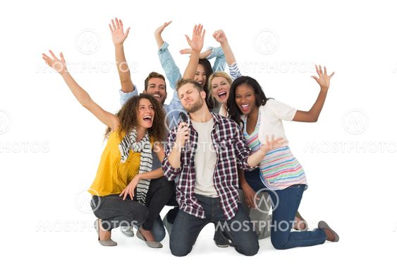 Smiling group of young friends having fun doing karaoke