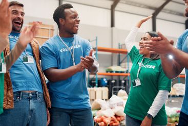 Volunteer group, happy and celebration with applause in...