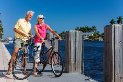 Happy Senior Couple on Bicycles By a River