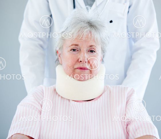 Portrait of a senior woman with a neck brace sitting on a wheelchair