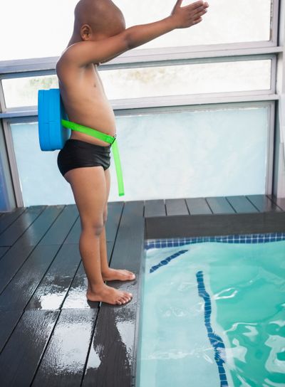 Little boy ready to dive in pool