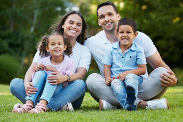 Parents, children and smile in portrait at park with...