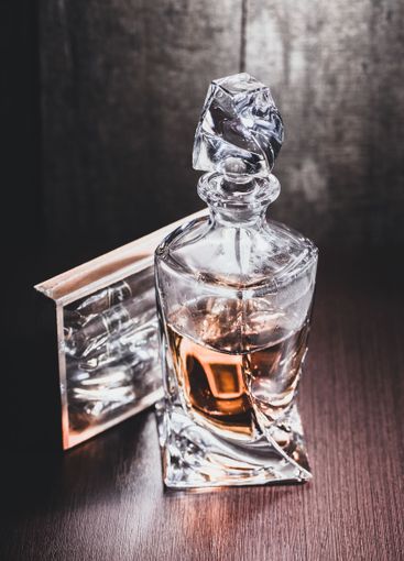 Whiskey glass in the dark close up