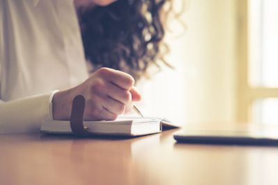 beautiful woman at home writing and working