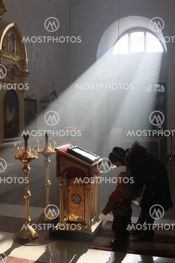 Prays in an Orthodox church.