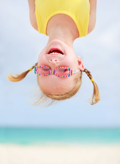Happy little girl upside down