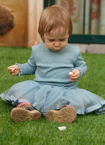 Curious little child girl outdoors. Childhood