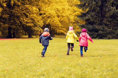 group of happy little kids running outdoors