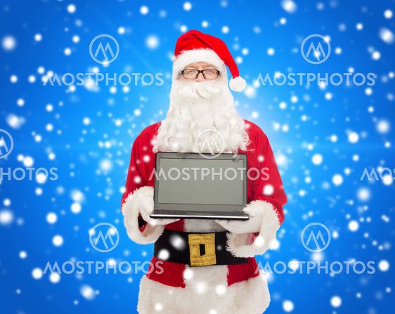 man in costume of santa claus with laptop