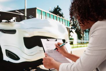 African American Car Insurance Agent Inspecting Accident