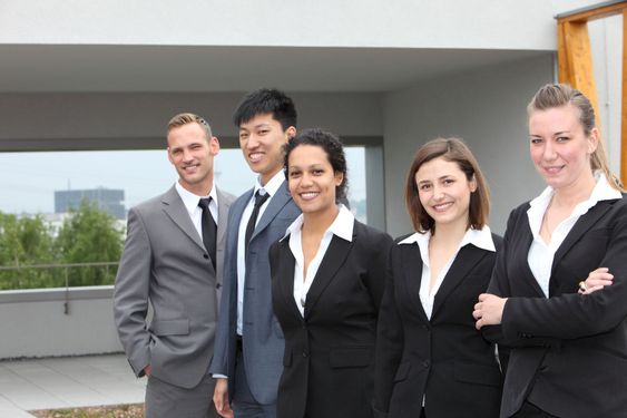 Confident business team standing together outdoors