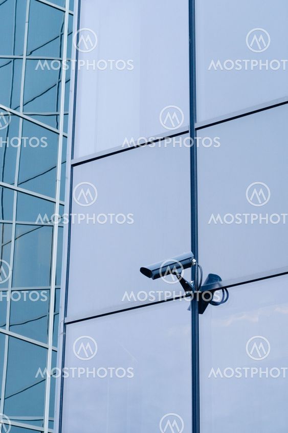 Outdoor surveillance camera on the wall of modern building