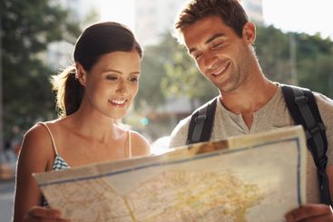 Happy couple, tourism and city with map for destination,...