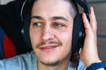 A man listens to music with deep concentration,...