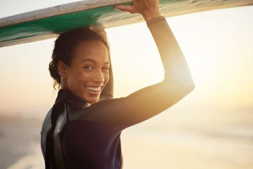 Happy, surfer or portrait of woman at sea for fitness...