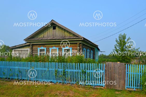 The wooden house in the village in the summer.