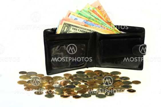 Many banknotes of different countries in the wallet. Black wallet with money.