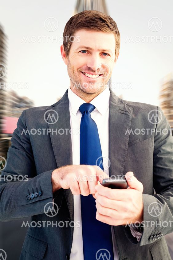Composite image of businessman sending a text message