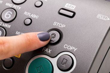 Woman's hand using fax machine close up