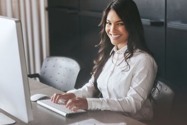 Happy, business woman or portrait with computer at...