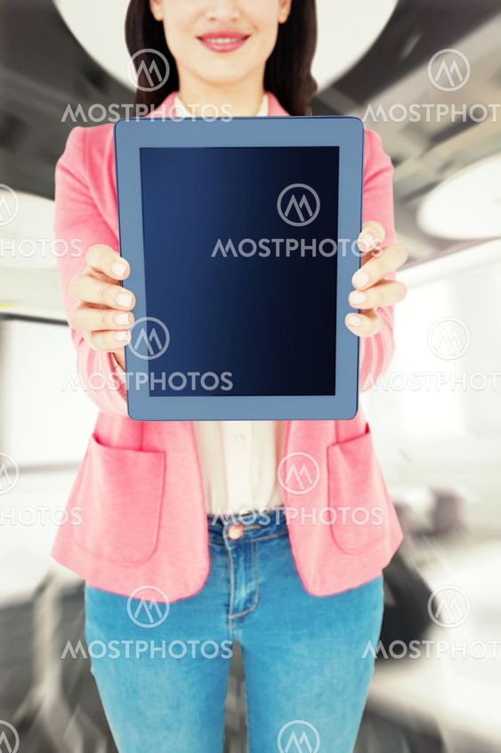 Composite image of elegant brunette using tablet