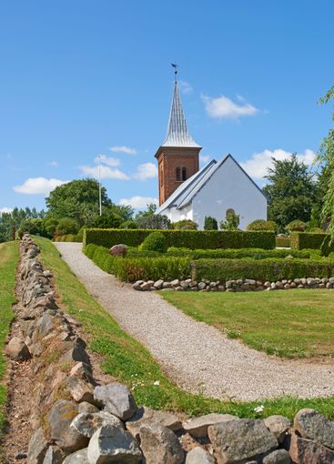 Rocks, grass field or church with blue sky, path or...