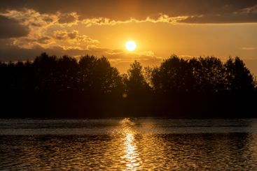 the lake with orange water in the summer at sunset