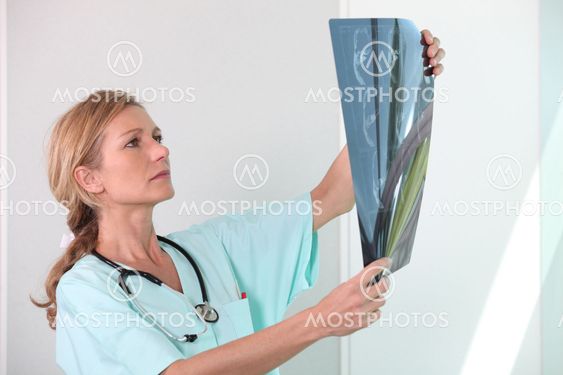 Nurse looking at X-ray