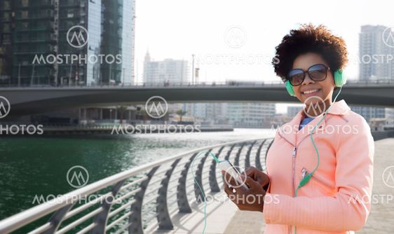 happy young woman with smartphone and headphones