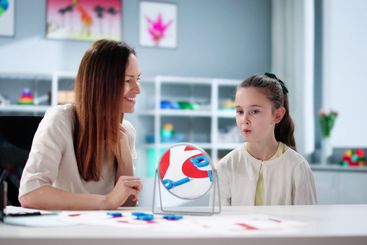 Young child learns to speak with speech therapist's...