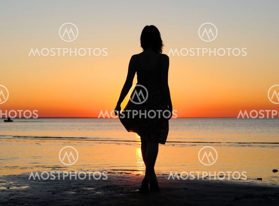 Woman as silhouette by the sea