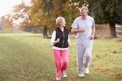 Senior Couple Power Walking In The Park