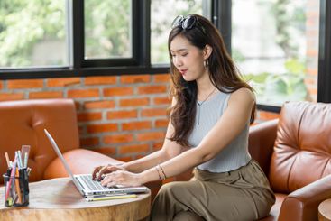 Portrait of Asian business female using laptop beautiful...