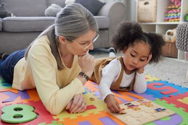 Teacher, therapist and little girl with ADHD for...
