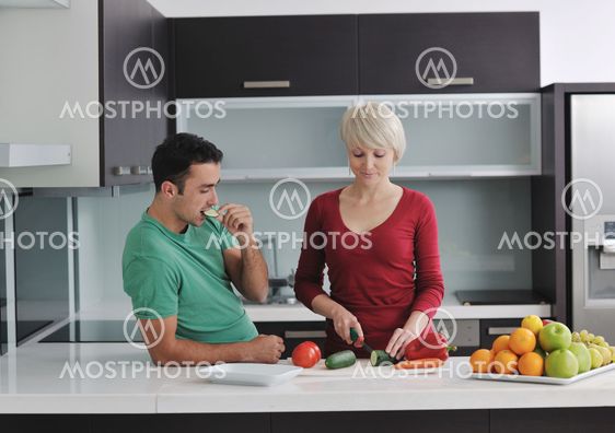 young couple have fun in modern kitchen