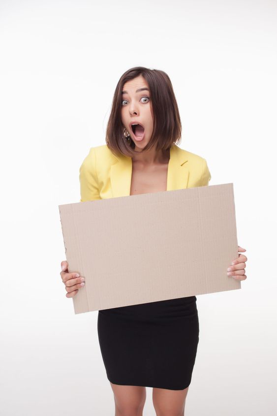 Businesswoman showing board or banner with copy space on...