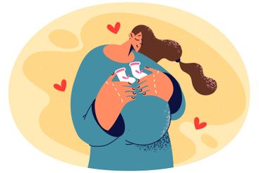 Smiling pregnant woman excited about motherhood