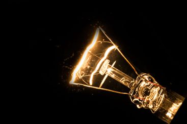 Close-up of electrical bulb on black background