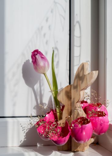 Creative vibrant handmade Easter table decoration with...