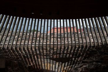 Sunlight entering through wooden ceiling roof slats in a...