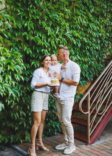 Mom and dad in nature with their one-year-old son...
