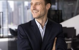 Cheerful confident Latin company executive man keeping...