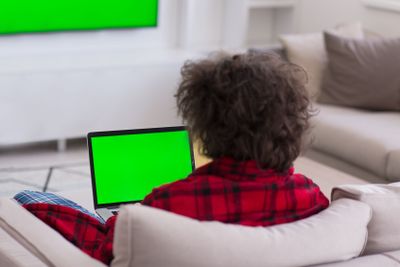 man freelancer in bathrobe working from home