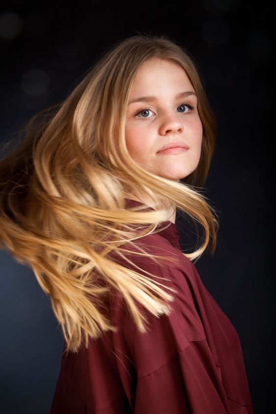 Scandinavian cute young girl portrait with hair in movement