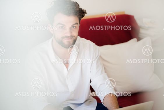 handsome hipster modern man working home using laptop