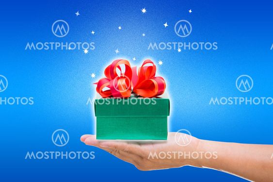 Green gift box with hand on blue background
