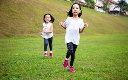 Asian Little Chinese Sisters running happily