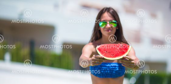 Young happy girl in hat and sunglasses with watermelon...