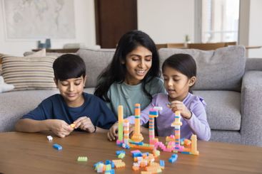 Loving Indian mother play with little children