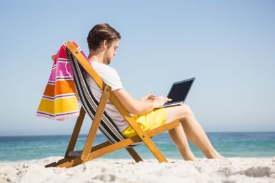 Man relaxing and using laptop